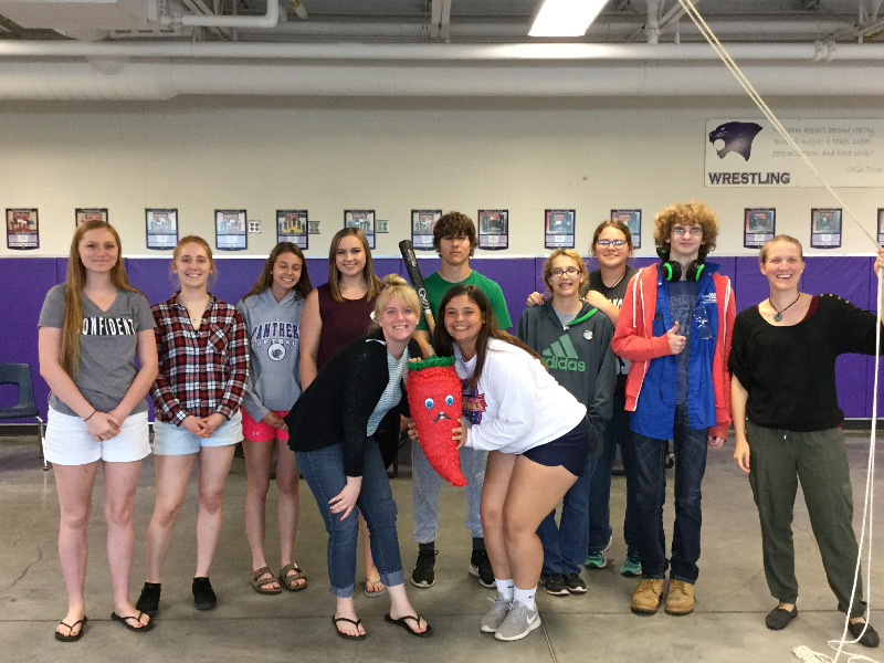 Photos of the students breaking down a piñata