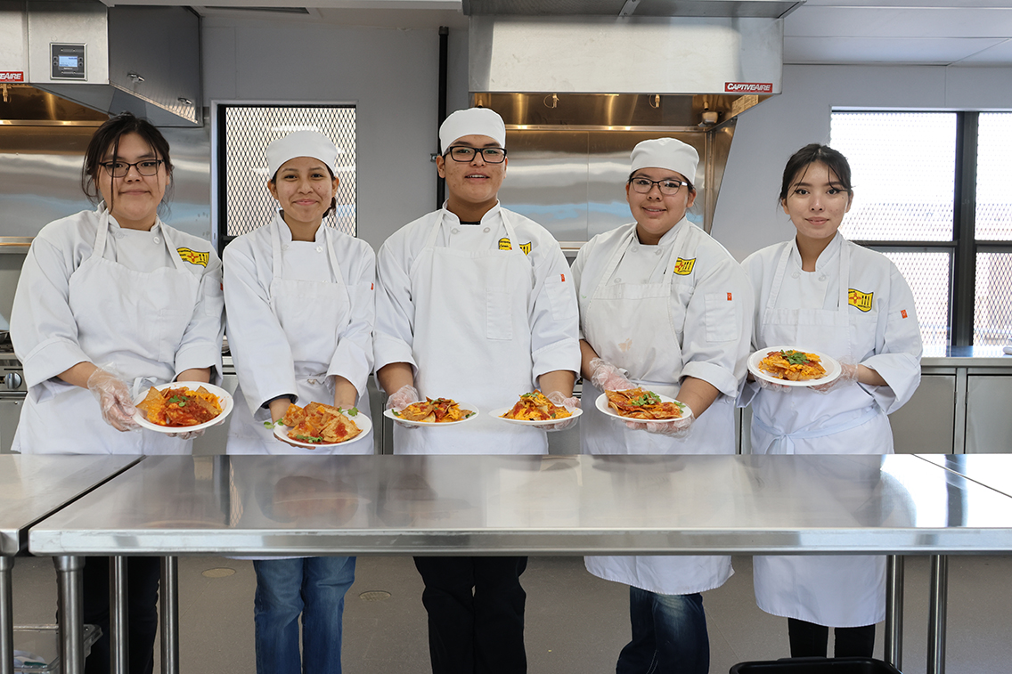 culinary students holding plates of food