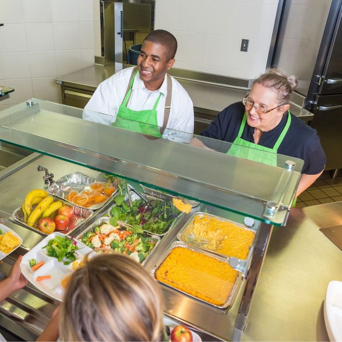 two people serving lunch