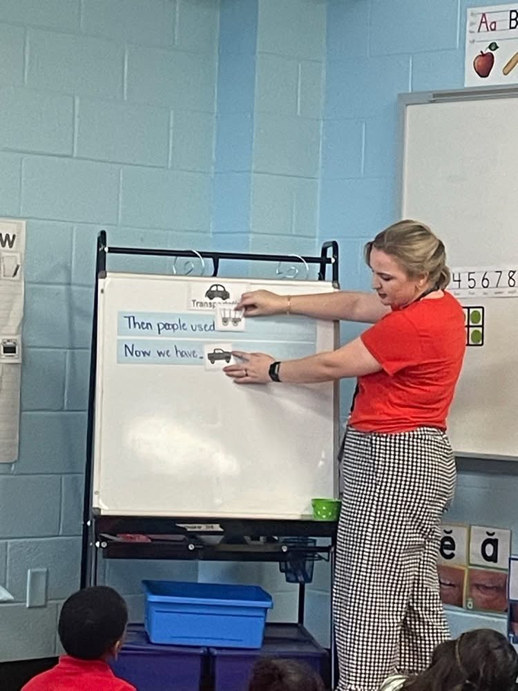 Teacher pointing to a chart.