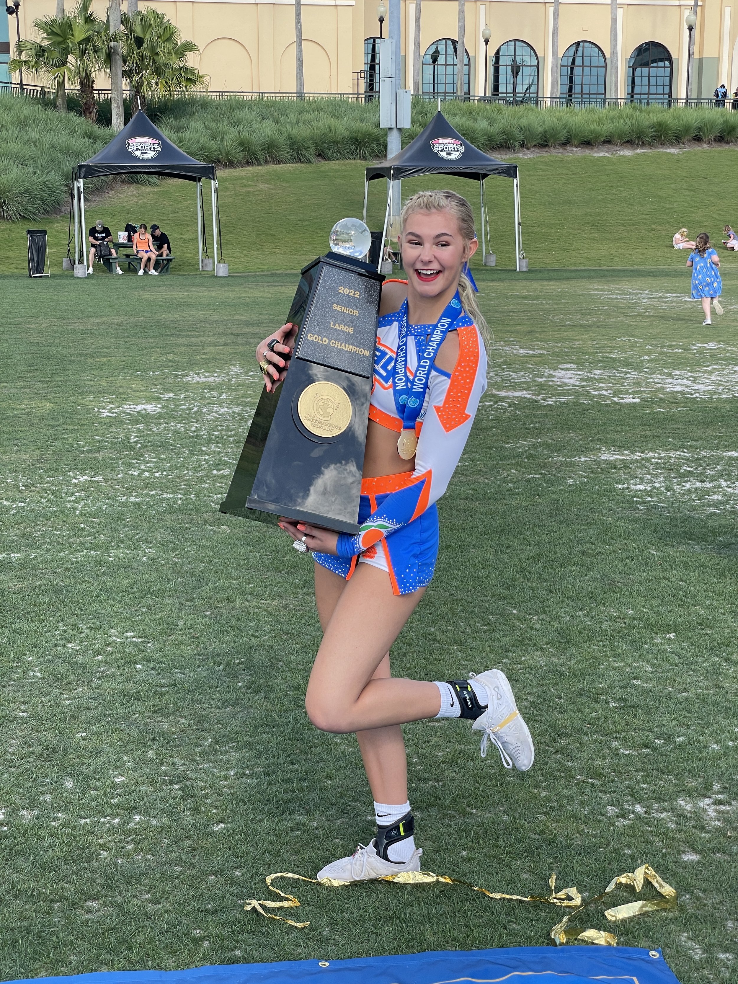 student holding a trophy smiling