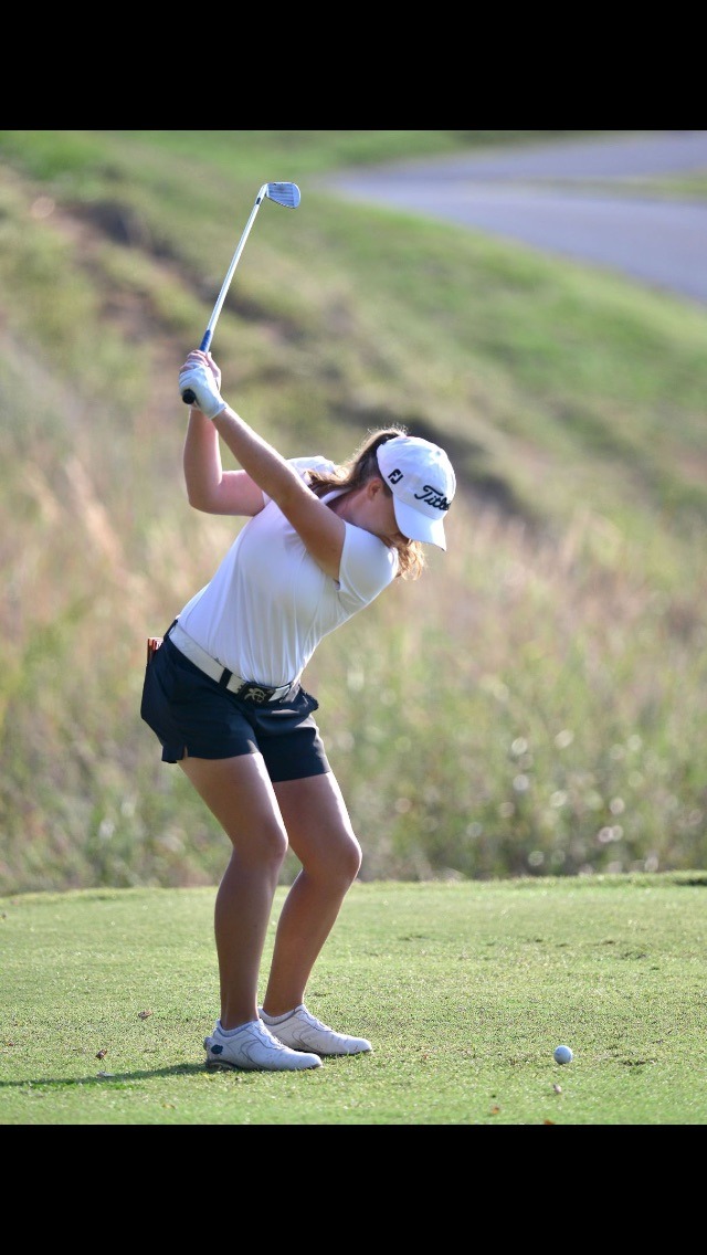 women playing golf about to hit the ball