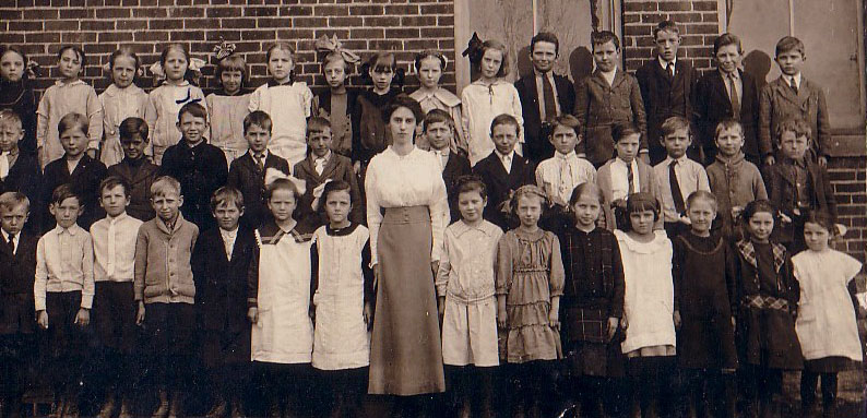 Students pose in front of “Fairview”, with their teacher.