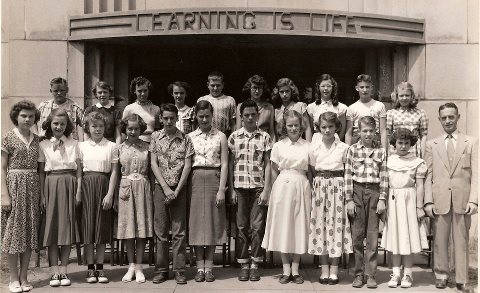 Mr. Walter Arnold (far right) posing with his 6th grade class in 1957