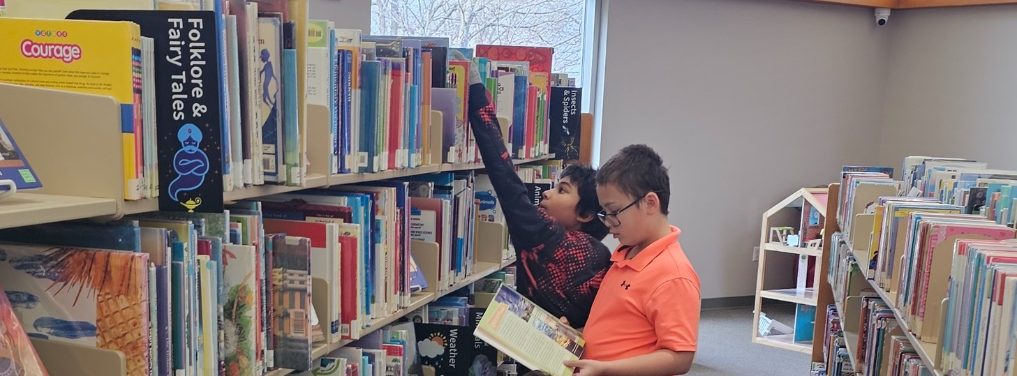 Three boys browsing for books