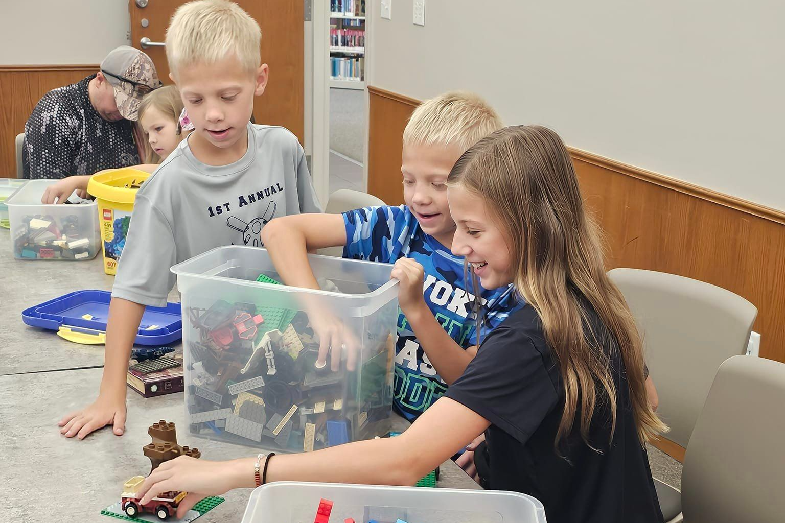 Image of three kids playing with Lego