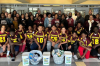 football players and adults with gifts from NCCU '04
