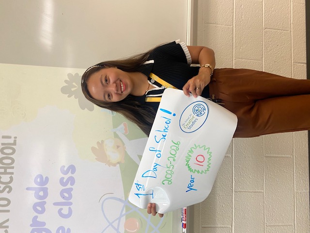 teacher holding sign showing how many years at the district