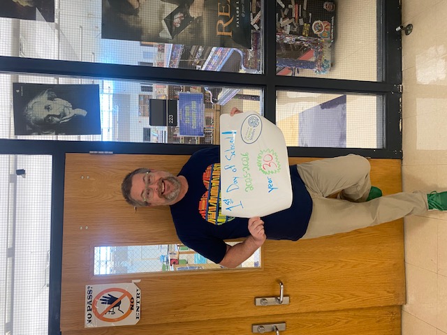 teacher holding sign showing how many years at the district