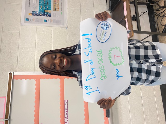 teacher holding sign showing how many years at the district