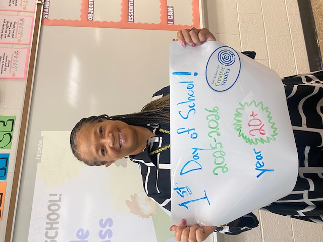 teacher holding sign showing how many years at the district