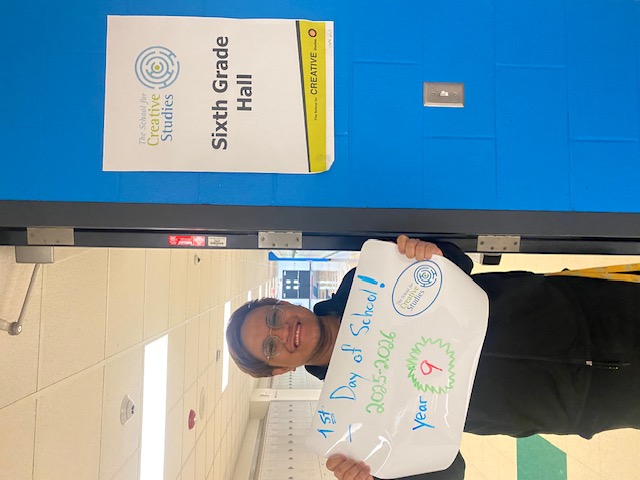 teacher holding sign showing how many years at the district
