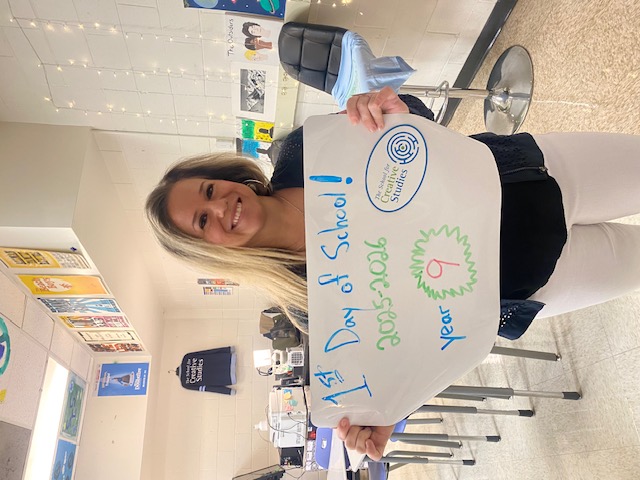 teacher holding sign showing how many years at the district