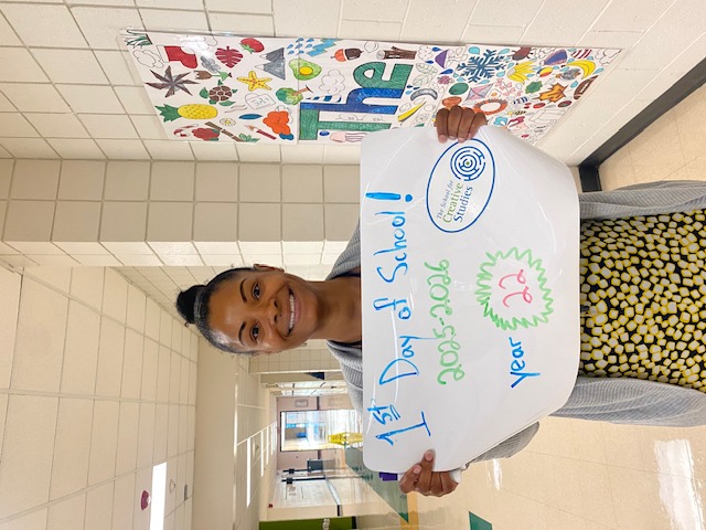 teacher holding sign showing how many years at the district