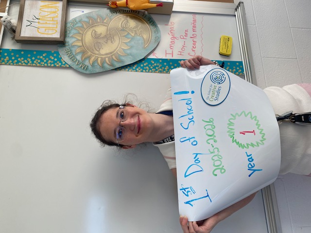 teacher holding sign showing how many years at the district