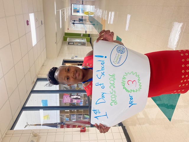 teacher holding sign showing how many years at the district