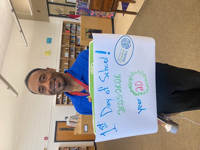 teacher holding sign showing how many years at the district