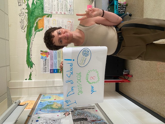 teacher holding sign showing how many years at the district