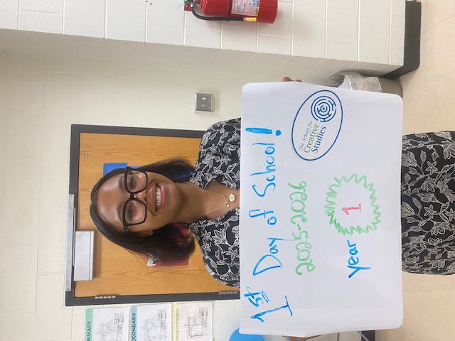 teacher holding sign showing how many years at the district