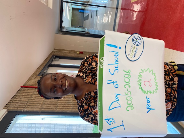 teacher holding sign showing how many years at the district