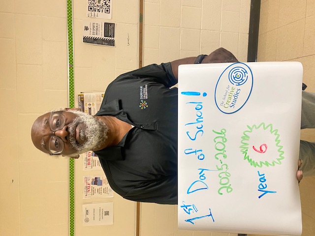 teacher holding sign showing how many years at the district