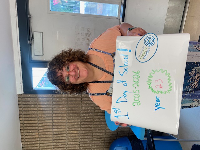 teacher holding sign showing how many years at the district