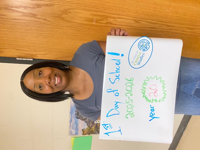 teacher holding sign showing how many years at the district