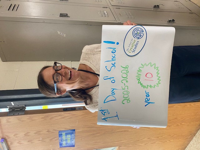 teacher holding sign showing how many years at the district