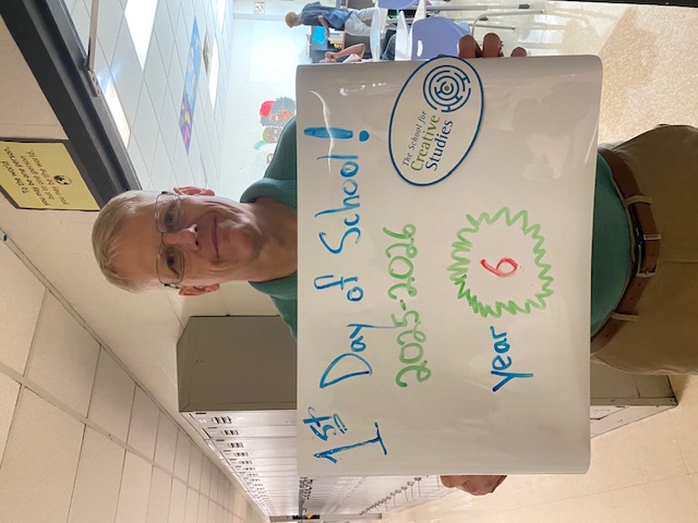teacher holding sign showing how many years at the district