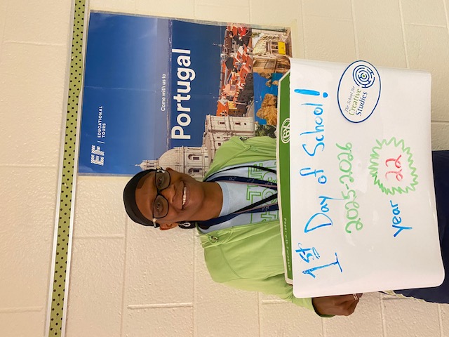 teacher holding sign showing how many years at the district