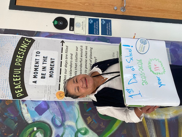 teacher holding sign showing how many years at the district