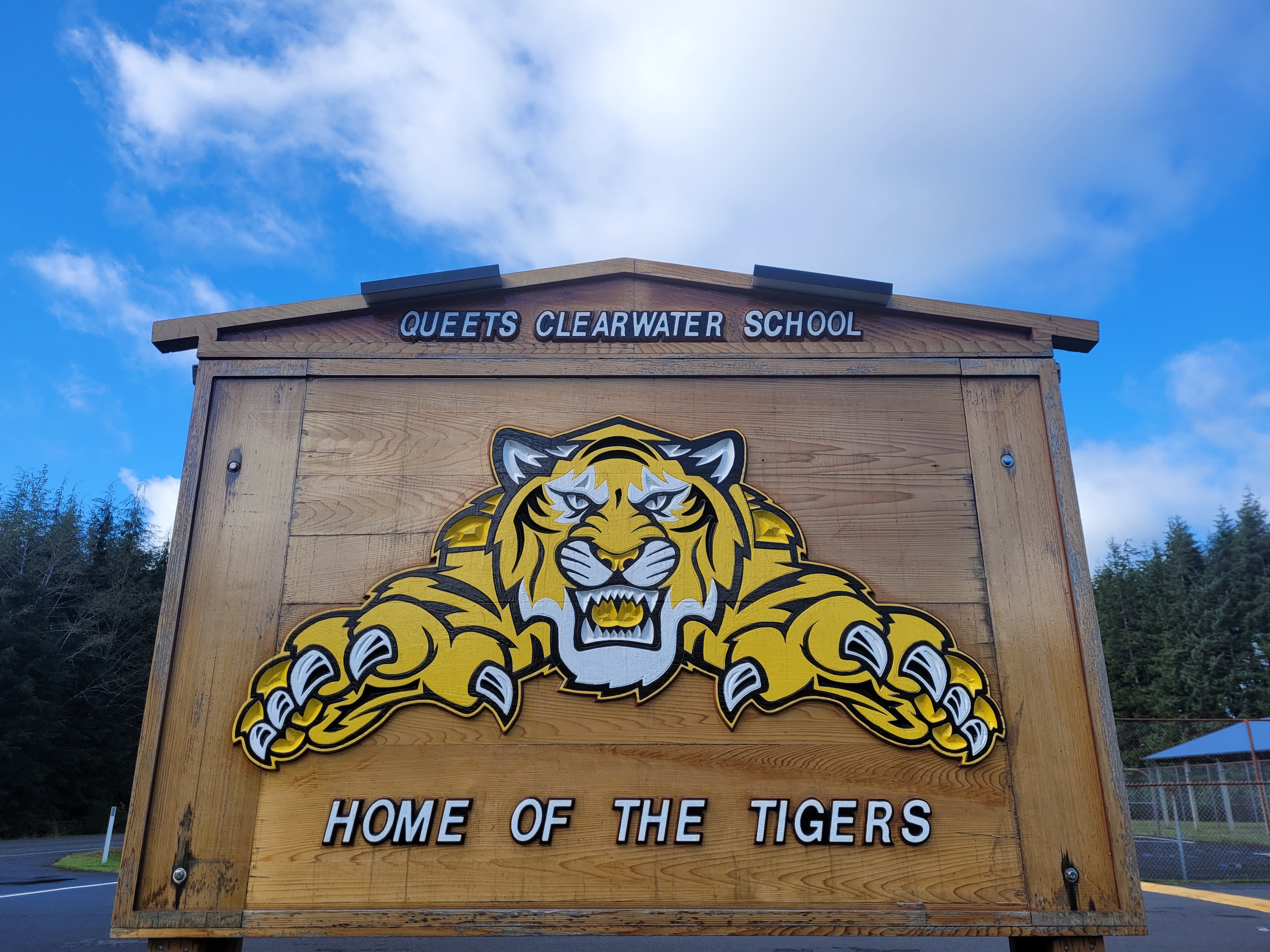 Queets Clearwater Sign outside with blue sky and some clouds