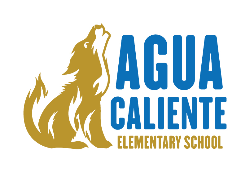 Aqua Caliente Elementary School building with a playground and trees in the foreground under a clear blue sky.