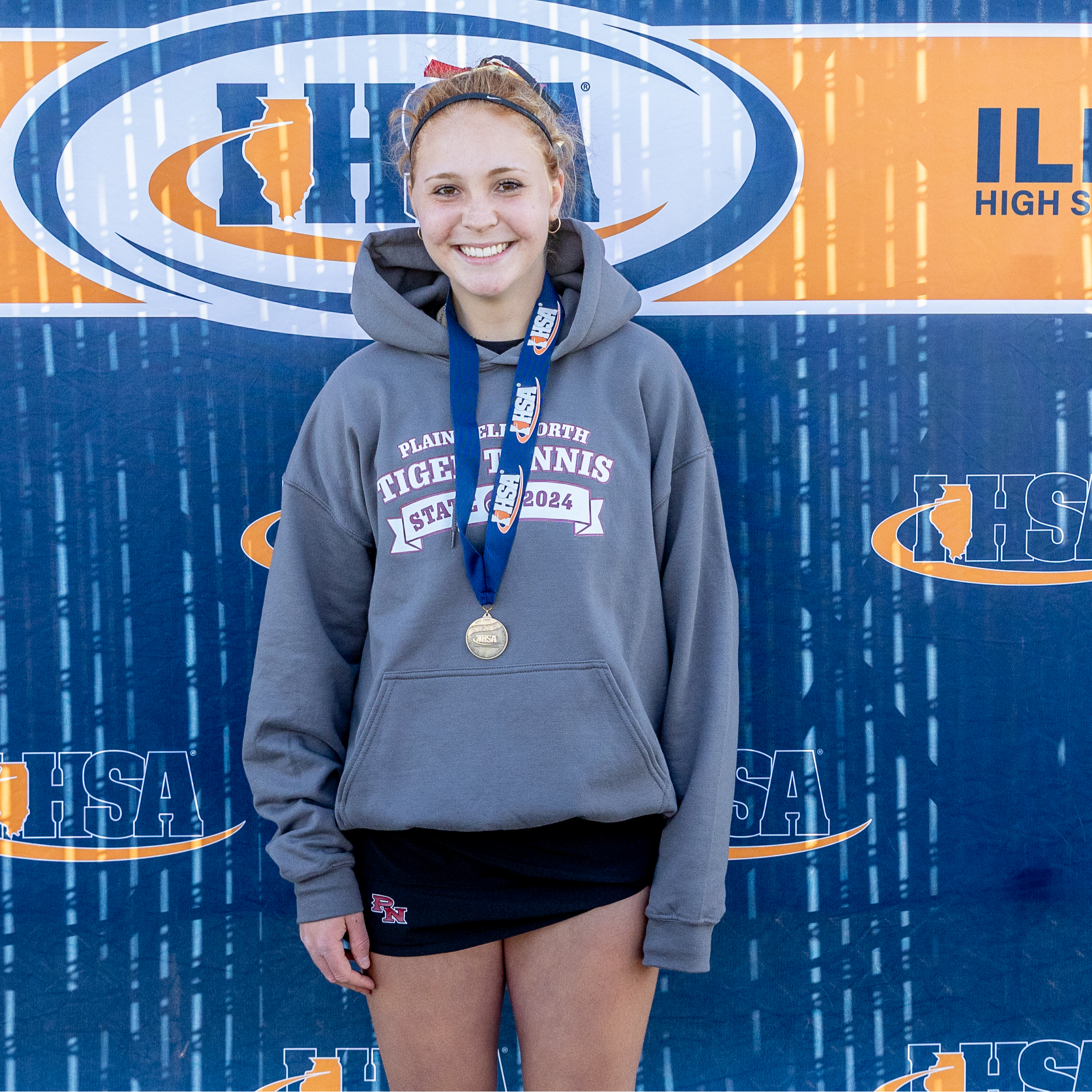 PNHS senior Jessica Kovalcik  standing in front of sign with her medal