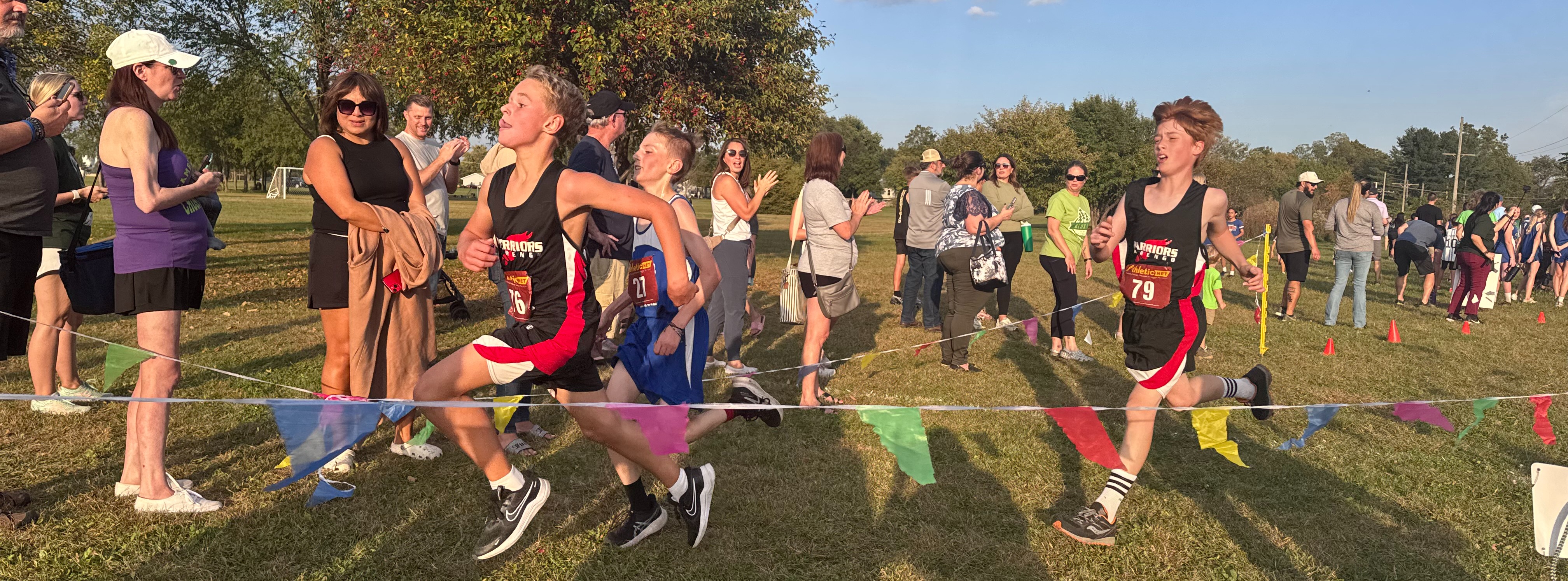 2 boys run to finish line