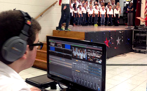A student live streaming a choir performance
