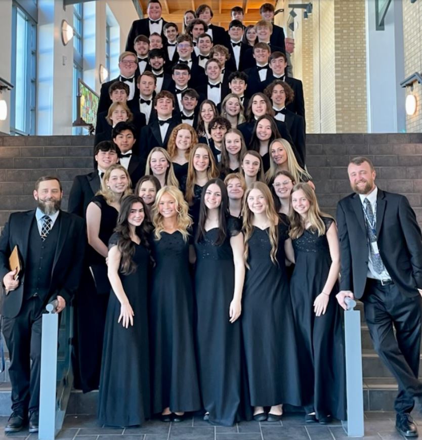 A group of choir students pose together