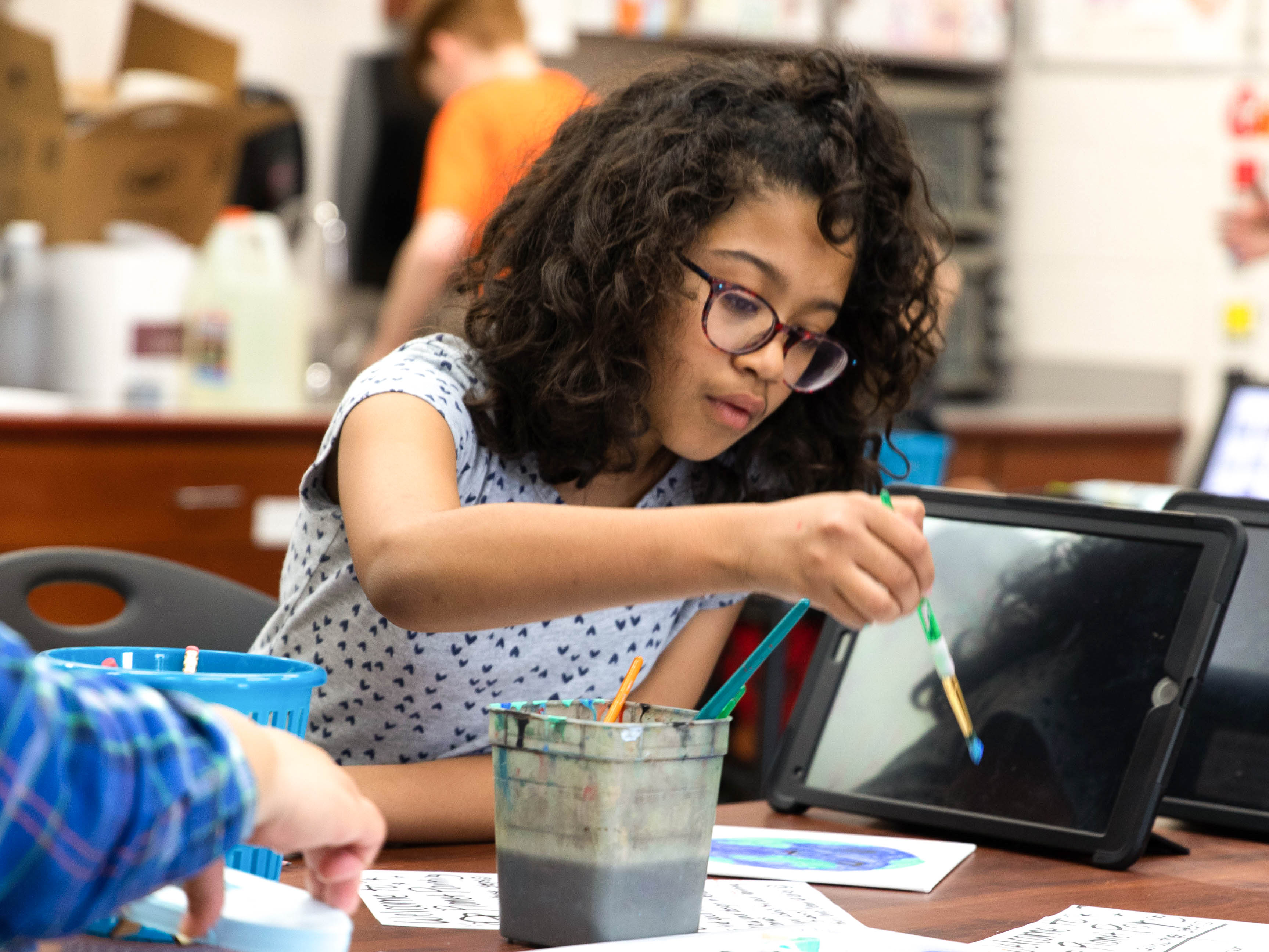 Photo of a student painting.