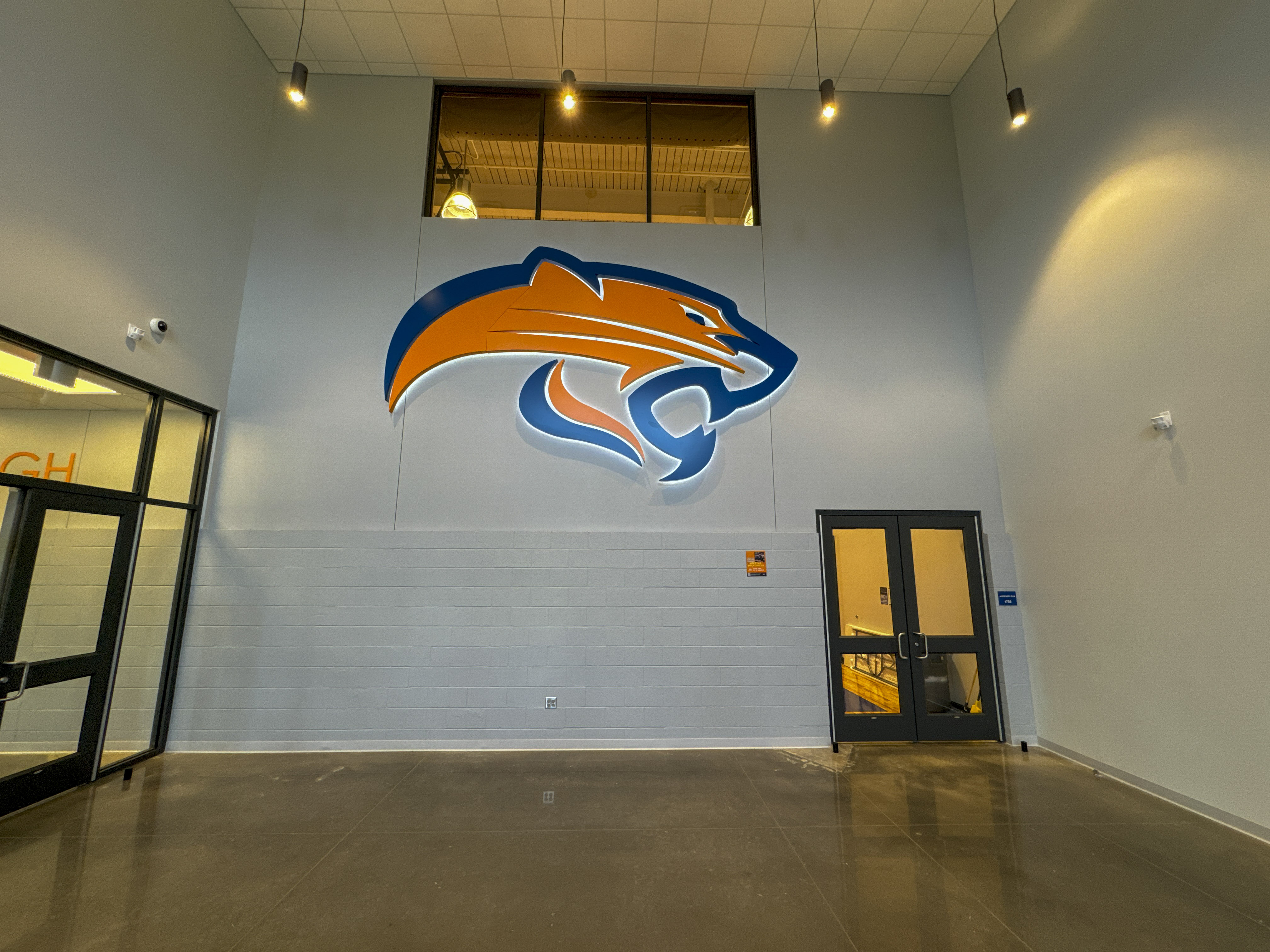 Interior of Southwest Jr. High Gym. With mascot logo painted on wall.