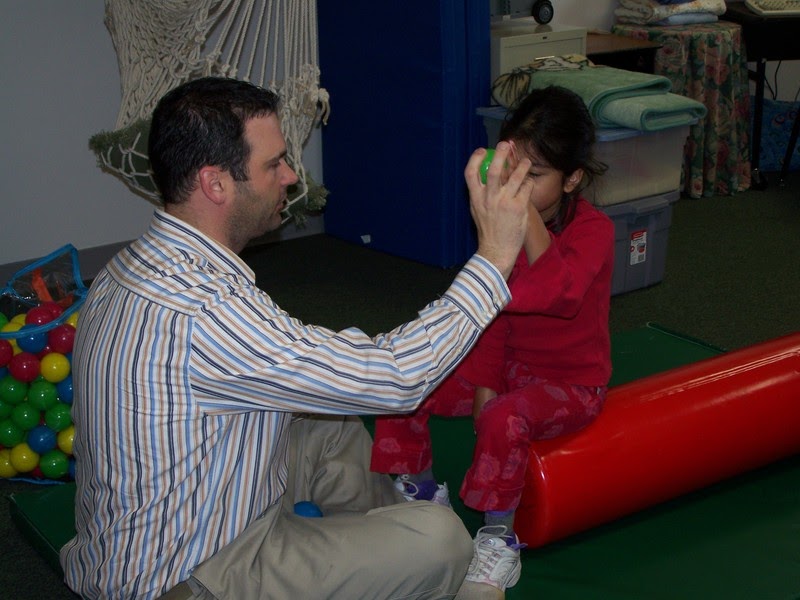 Photo of an occupational/physical therapist working with a student