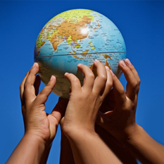 An image of children holding a globe