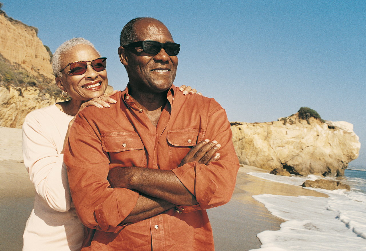 Joyful couple standing on a beach