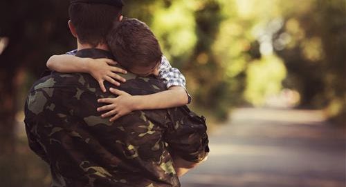 Military parent carrying a kid