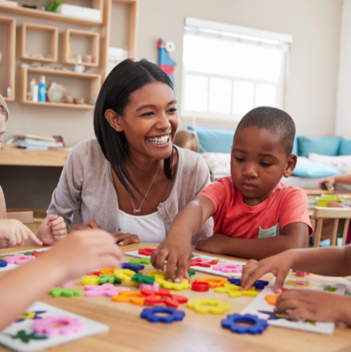 Teacher engaging children with activities.