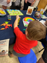 child next to table