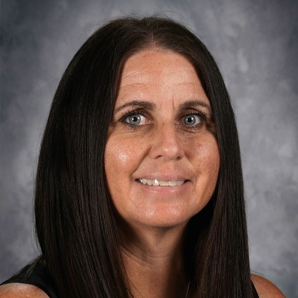 A woman with sleek, straight, medium-length hair, wearing a black top, posed against a soft, neutral background.