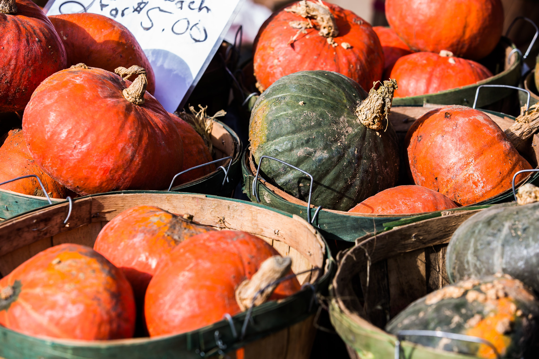 Colorful photo of winter squash in wooden baskets