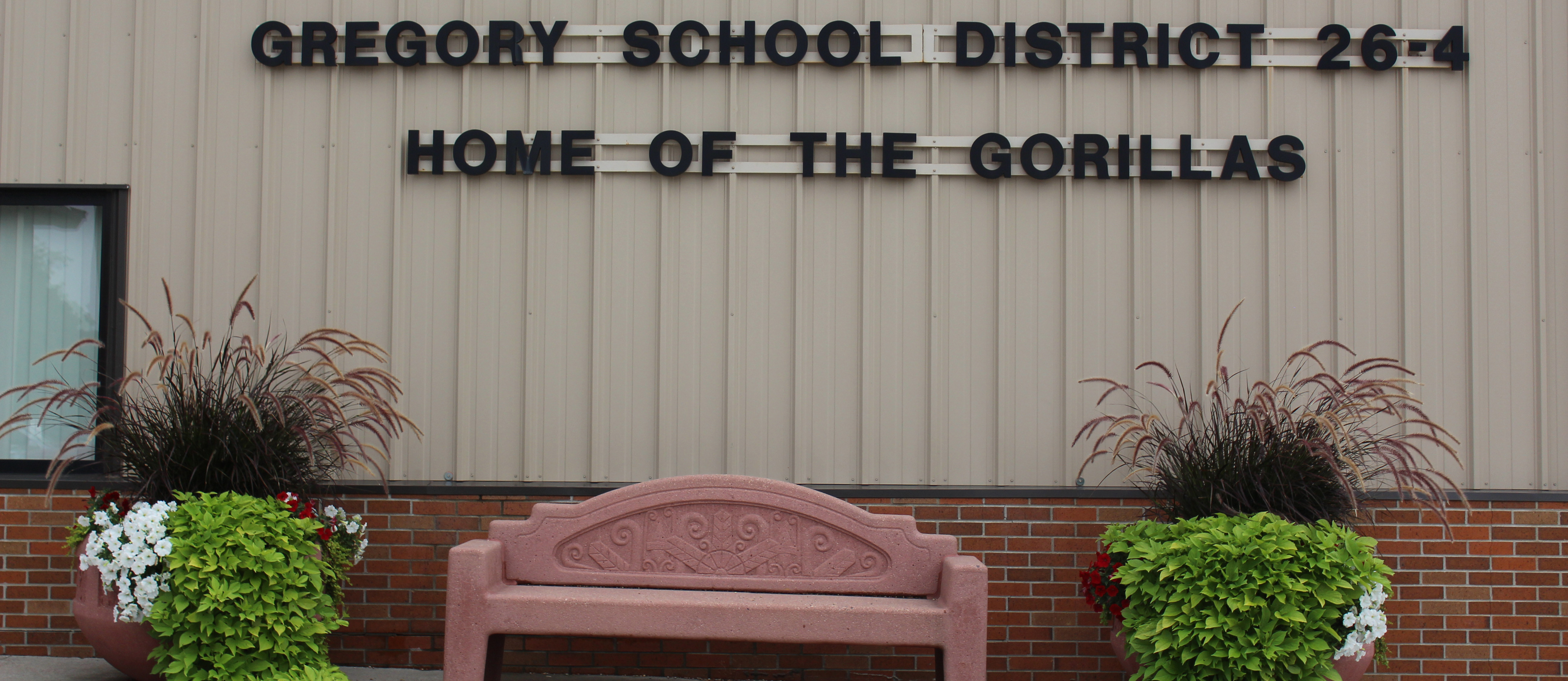 Picture of the bench in front on High School with planters on both sides