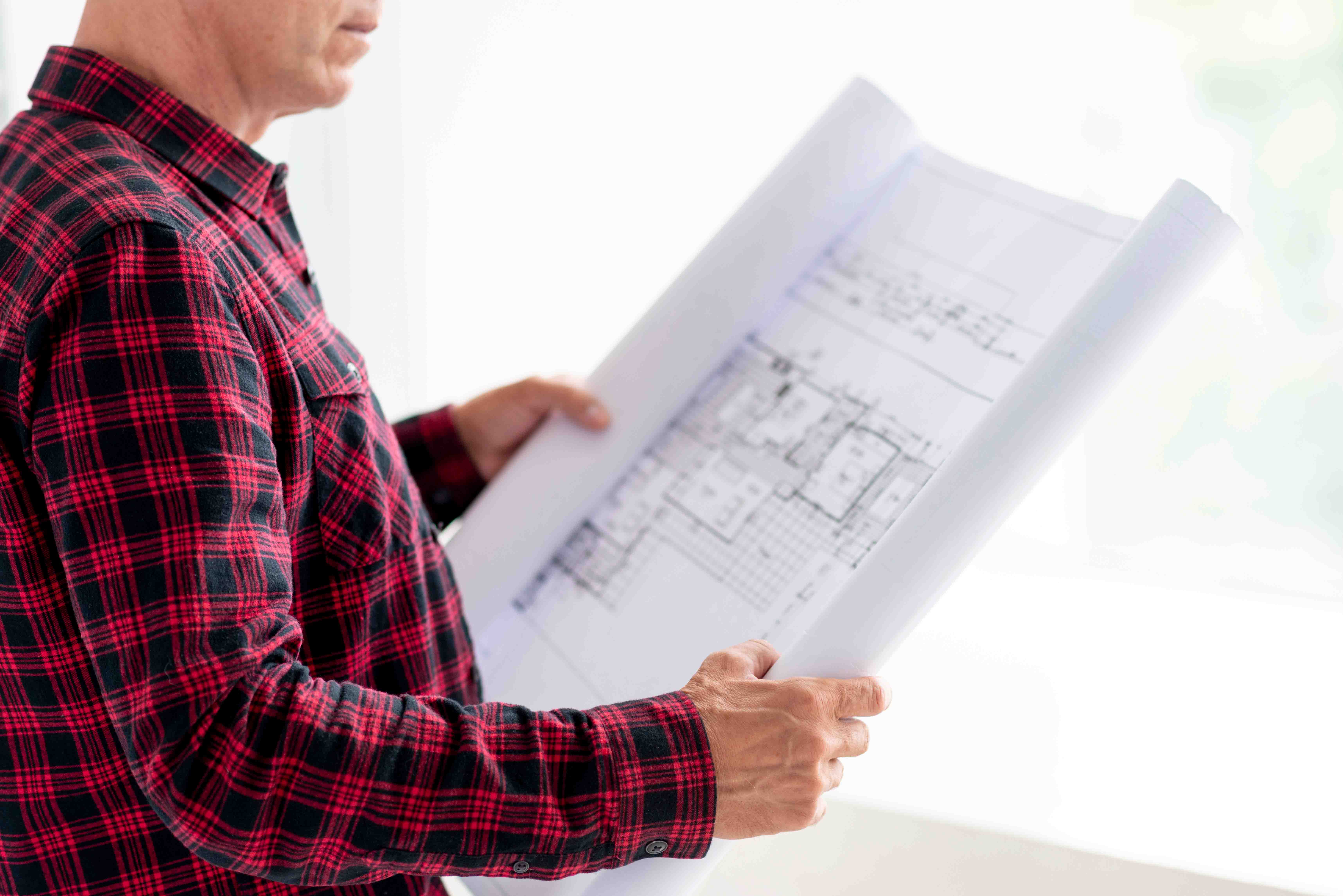 Over the shoulder shot of person reviewing building plans