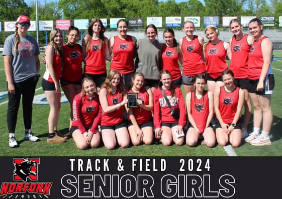 A group of senior girls track team posing for a photo.